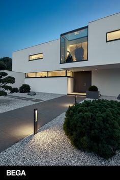 an exterior view of a modern house at night