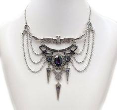 "This dramatic Gothic Vampire Bat necklace features an antique silver open winged bat, filigrees and pendants, adorned with dazzling DARK AMETHYST VIOLET PURPLE glass jewels. This piece is then finished off with perfectly draped stainless steel cable chain. Decorated length portion is 5 3/4\" wide and 4\" tall in the very center (bat ears to bottom point). Necklace is adjustable 15\"-18\" in length. It is worn with soldered stainless steel cable chain and closes with a lobster clasp. If you woul Vampire Jewelry Necklaces, Oc Accessories, Bat Ears, Vampire Jewelry, Bat Necklace, Dark Amethyst, Victorian Necklace, Wire Wrapped Jewelry Diy, Gothic Vampire