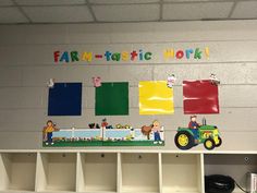 a farm - to - plastic work display on the wall in a school room with toys and bookshelves