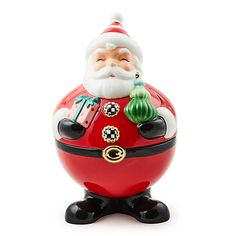 a santa clause figurine sitting on top of a red ball