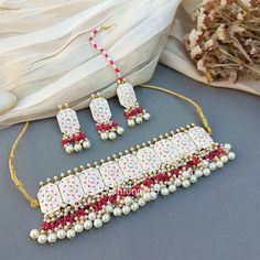 This Beautiful Meenakari White Colour Wedding Choker Necklace for Bride is very much in high trend gives you a real ethnic as well as royal look. Gold-toned Kundan Pearl Earrings have a floral base with stone-studded detail. This choker necklace set is designed for all age groups from college going girl to housewife. This is a piece of handcrafted kundan jewellery set with good quality Kundan and Pearl drops. For more, check out our latest fashion and kundan meena earrings and necklace set. Earr Festive White Meenakari Jewelry Sets, Ceremonial White Meenakari Jewelry Sets, Traditional White Jewelry With Mirror Work, Festive White Jeweled Kundan Necklace, White Jeweled Kundan Necklace For Festivals, White Meenakari Kundan Necklace For Ceremonial Occasions, Traditional White Meenakari Jewelry, Necklace For Bride, Wedding Choker Necklace