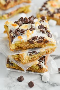 chocolate chip cookie bars stacked on top of each other with marshmallows scattered around them