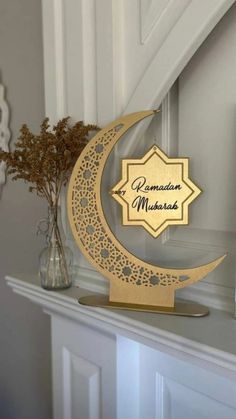 a wooden sign sitting on top of a mantle next to a vase filled with flowers