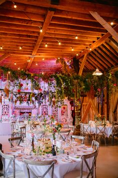 an indoor wedding venue decorated with flowers and greenery