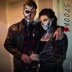 two people dressed up in skeleton makeup and holding wine glasses with the caption, look at me