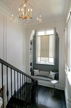 a living room filled with furniture and a chandelier hanging over the top of it