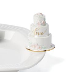 a wedding cake sitting on top of a white plate