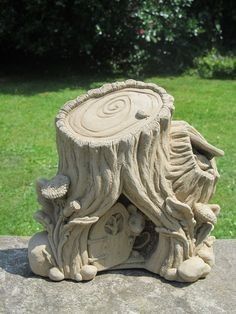 a carved tree stump with an animal house on it