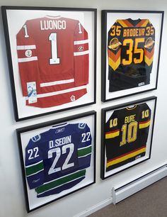 four framed hockey jerseys hang on the wall