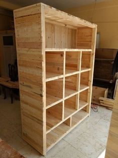 the shelves are made out of pallets and have been built into each other for storage