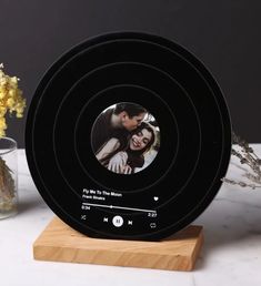 an image of a couple in the center of a clock with music playing on it