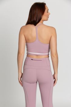 Our Mauve Mist White Line Crop Tank is the perfect addition to your athleisure collection. Featuring a white line detail, sleek Y-Back design, and sweat wicking material, this tank effortlessly takes you from your workout class to brunch with the girls.