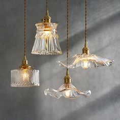 three glass lights hanging from the ceiling