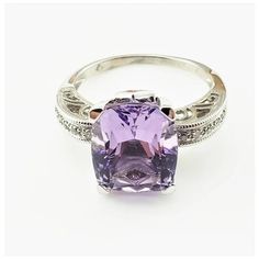 Vintage 14 Karat White Gold Amethyst and Diamond Ring-  This stunning ring features one cushion cut amethyst (12 mm x 9 mm), two square cut amethysts and ten round brilliant cut diamonds set in elegant 14K white gold.    Shank:  1.5 mm  Amethyst carat weight:  8.50 ct. (Amethyst weighed and authenticated by GAI)  Amethyst clarity grade:  AAA  Total diamond weight:  .05ct.  Diamond color:  champagne  Diamond clarity:  L-N  Ring Size:  8  Weight:  3.0 dwt. / 4.8 gr.  Tested for 14K gold.  Very good condition, professionally polished.  Will come packaged in a gift box or pouch (when possible) and will be shipped U.S. Priority Mail Insured. Luxury Purple Amethyst Ring, Rectangular Shape, Luxury Purple Amethyst Rectangular Ring, Luxury Purple Rectangular Amethyst Ring, Luxury Rectangular Amethyst Ring, Formal Purple Rings With Rectangular Stone, Formal Amethyst Cushion Cut Ring With Accent Stones, Formal Purple Amethyst Ring With Rectangular Shape, Luxury Purple Cushion Cut Jewelry, Formal Rectangular Amethyst Ring