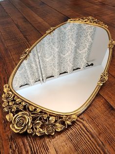 a mirror sitting on top of a wooden floor