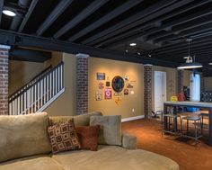 a living room filled with furniture next to a kitchen and dining area in an apartment