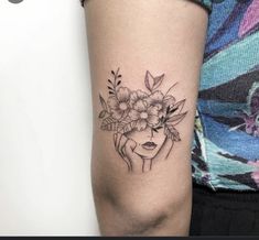 a woman's arm with a flower tattoo on the left side of her arm