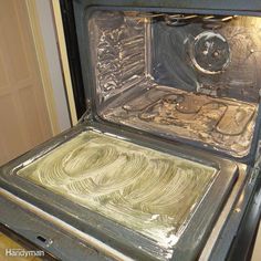 an oven with some food cooking inside of it's burners and the door is open