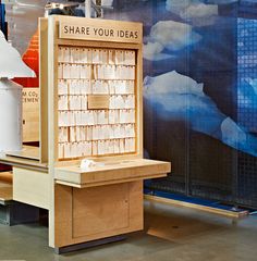 a display case with lots of books on it in a room filled with other items