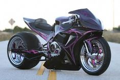 a black and purple motorcycle parked on the street