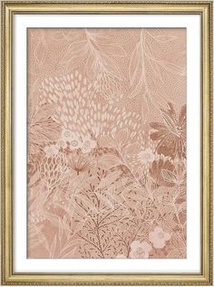 an ornate gold frame with pink flowers and leaves on the wall in front of it