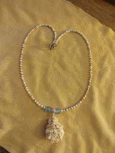 This necklace features a very nice coral fossil found in the Caribbean on a beach on Puerto Rico. It is wrapped in rose gold colored copper wire. The beads used are African sea glass, rare auralite-23, sea jasper and antique glass opalescent Venetian beads. The handmade toggle clasp is patina copper from Mykonos, Greece. Approximately 24 inches (60.1 cm) long. Capsule Necklace, Beach In Puerto Rico, Sea Jasper, Beneath The Sea, Ancient Beauty, Ancient Mysteries, Copper Patina, Soothing Colors, Jasper Beads