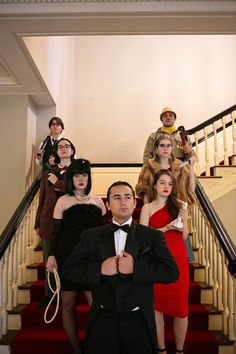 a group of people dressed in costume standing on stairs