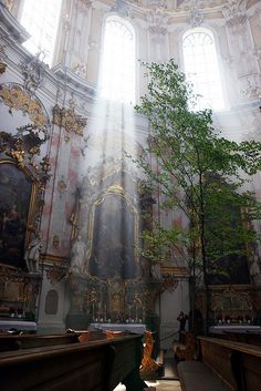 the sun shines through two windows in an ornate building