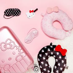 hello kitty accessories are laid out on a pink surface, including an inflatable toy