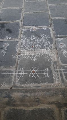 the sidewalk is decorated with white designs on it