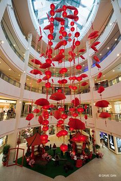 a large atrium with red lanterns hanging from the ceiling