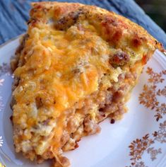 a piece of quiche sitting on top of a white and blue flowered plate