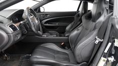 the interior of a car with black leather seats