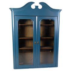 a blue china cabinet with two glass doors