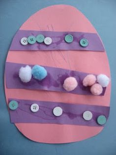 an easter egg craft with buttons and yarn