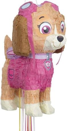 a pink and brown dog pinata on top of a white pole next to a stick