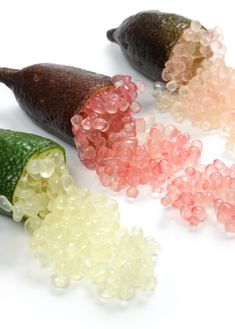 three pieces of fruit sitting next to each other on top of a white countertop