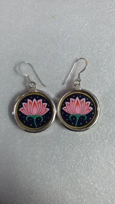 Hand Painted Miniature Art Painting Beautiful Flower Of Life Lovely Pink Lotus Flower 92.5 Sterling Silver Handmade Beautiful Glass Framed Earring Pair. Primary Colour Is Silver Earring Pair Length With Loop 4.5cm. Earring Width 2.3cm. Earring Weight 6.5 gms. It's a Totally Handmade Glass Framed Earring Pair Covered By 92.5 Sterling Silver And Glass. Used Natural Water Colours on Paper Sheet. Your Feedback is very Important for us so leave positive Feedback. If you have any Problem or you are no Traditional Flower-shaped Earrings With Ear Wire, Multicolor Round Flower Earrings, Elegant Hand-painted Flower Earrings, Elegant Hand Painted Flower Earrings, Adjustable Flower Earrings For Gifts, Artistic Flower-shaped Earrings For Gifts, Flower-shaped Floral Print Earrings For Gift, Traditional Flower-shaped Jewelry With Ear Wire, Elegant Hand Painted Drop Flower Earrings