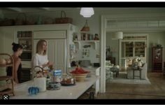 two women standing in a kitchen preparing food