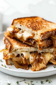 grilled cheese and onion sandwich on a white plate