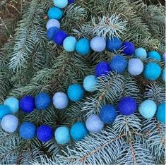 some blue and white balls hanging from a tree