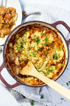 a casserole dish is shown with a wooden spoon in it and another side dish