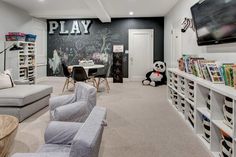 a playroom with lots of toys and books on the shelves in front of it