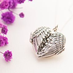 Our stunning handcrafted angel wing locket is made from Sterling Silver. The angel wings open up to allow you to safely keep a picture or memory inside. The detail of the feathers on the angel wings is highlighted beautifully with oxidised highlights. The locket will arrive on a 16" Sterling Silver trace chain, if you would like to upgrade your chain for a longer length or alternative style chain, please see my other chain options below This lovely and detailed angel wing locket would make a bea Spiritual Winged Jewelry For Gift, Winged Engraved Jewelry For Gifts, Angel Wings-shaped Jewelry As Gift, Angel Wings Jewelry Gift, Angel Wings Heart Pendant Jewelry For Gifts, Angel Wings-shaped Jewelry For Gifts, Angel Winged Jewelry For Gifts, Spiritual Angel Wings Jewelry For Gifts, Valentine's Day Angel Wings Jewelry Gift