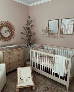 a baby's room with pink walls and furniture