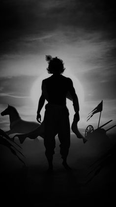 the silhouette of a man standing in front of two horses