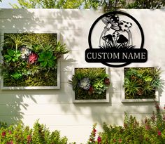 a sign that says custom name with succulents and plants on it's side