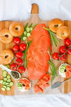 bagels and lox on a cutting board with salmon