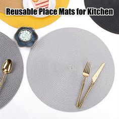 there are place mats for the kitchen with gold forks and spoons on top of it