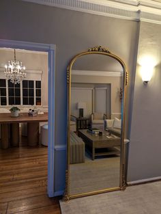 a living room with a large mirror on the wall